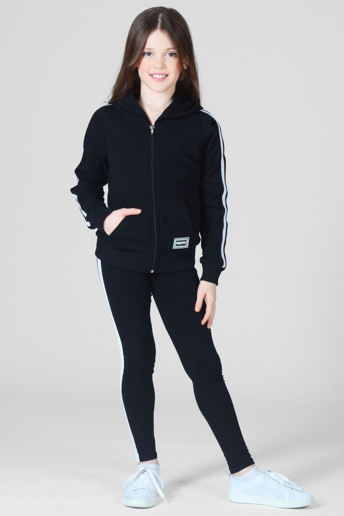 Girl wearing black full length Leggings and black zip jacket white stripe