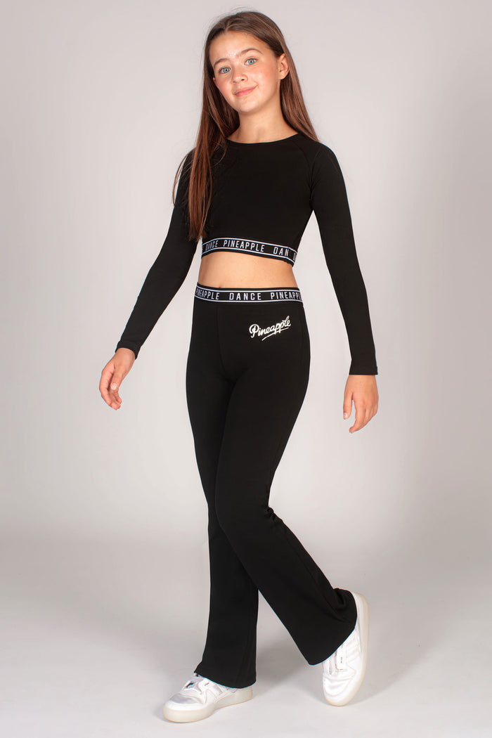 Black fitted crop top with long sleeves made in stretchy fabric is perfect for girls exercising and dancing.