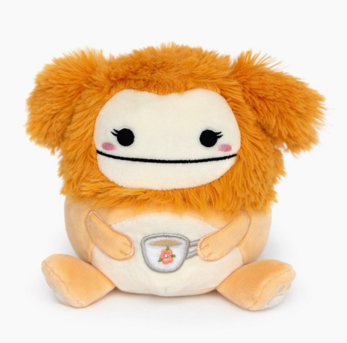 Plush toy with orange fur and a white belly on a white background