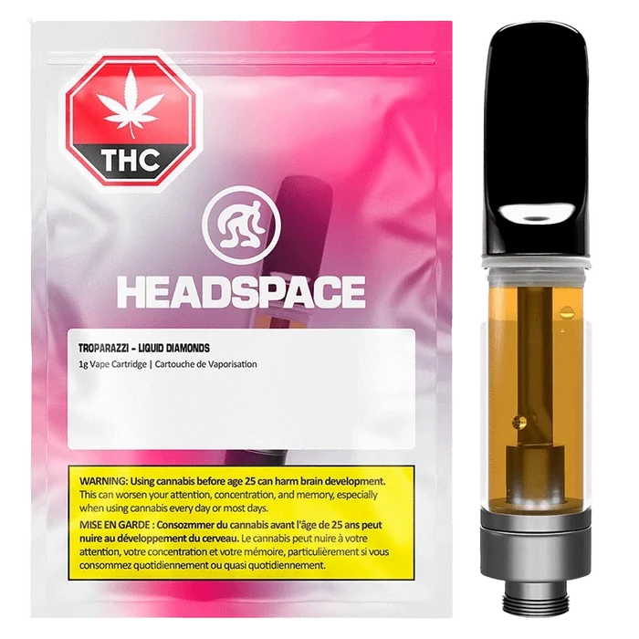Front-facing image of a Troparazzi Liquid Diamond Vape Cartridge showing the amber-filled cartridge beside pink-gradient Headspace packaging.