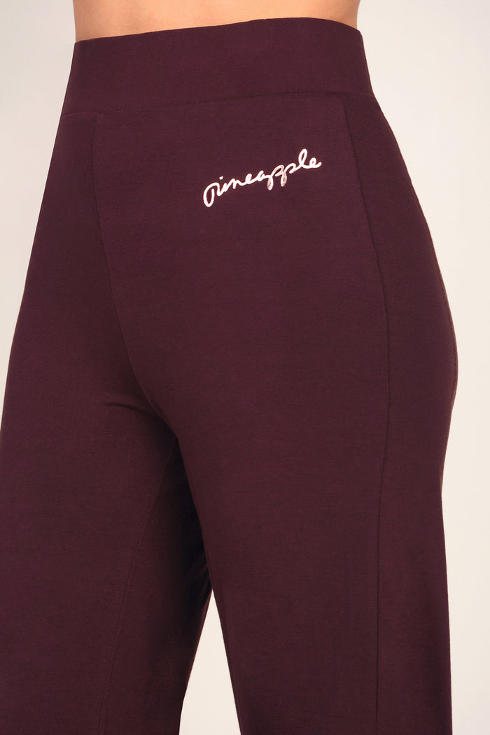 Detail shot of viscose trousers with small rose gold foil logo