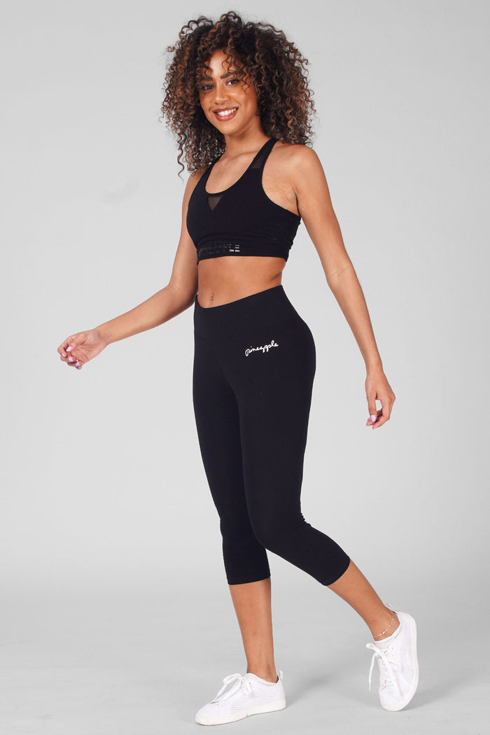 Woman wearing Black Wide Band Crop Leggings and Logo Black Mesh Bra Top